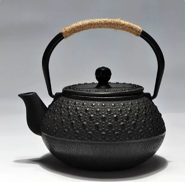 Japanese cast iron teapot in black with Peony pattern, showing lid, handle, and spout.