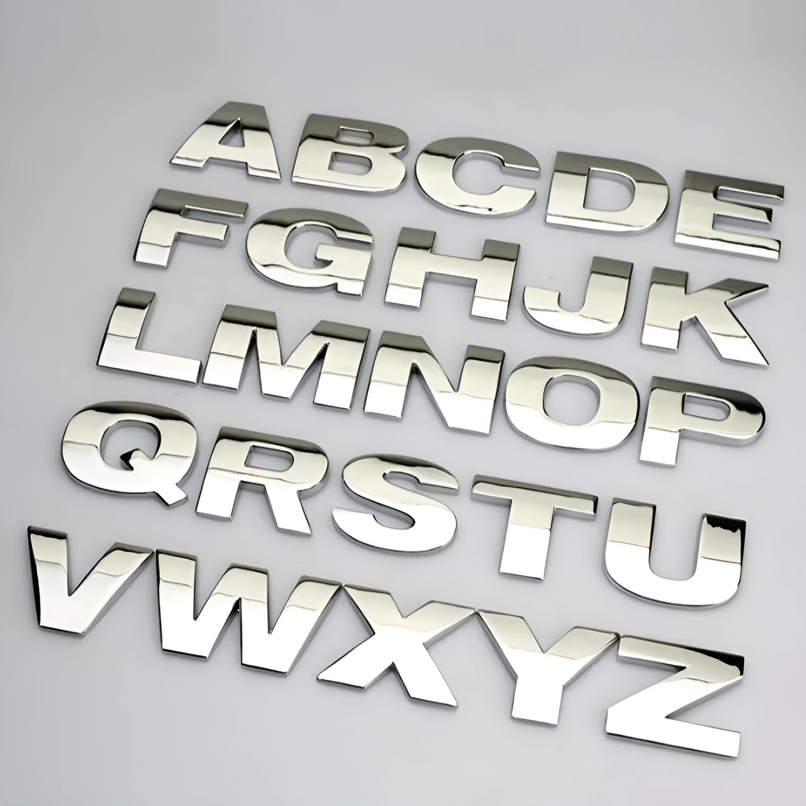 Zinc alloy metal car bumper sticker showing raised 3D letter design in approximately 2.5cm size