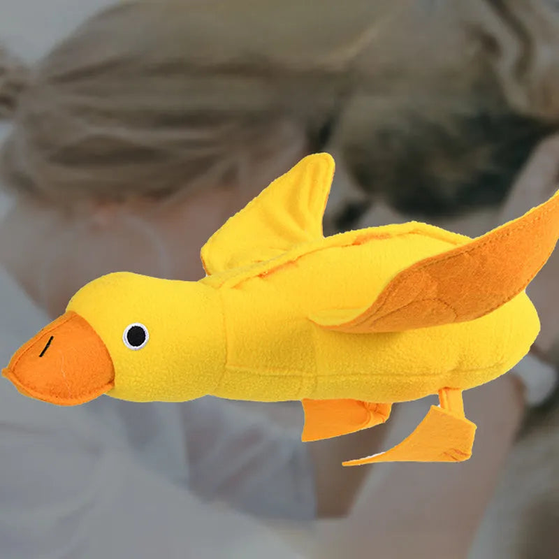Yellow plush teddy dog toy with internal squeaky duck for training and food leak feature