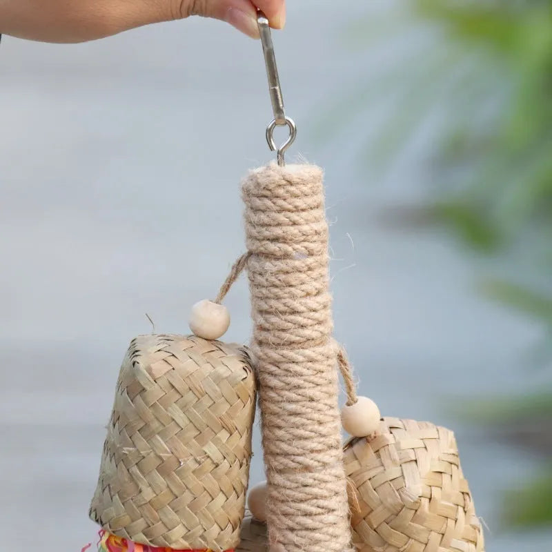 Colourful parrot chew toy with wood base, sisal rope and blue shredded paper attachments