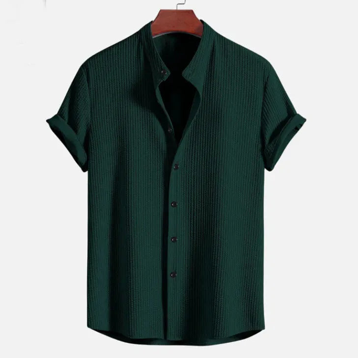 Man wearing a loose-fit short sleeve casual shirt in a solid colour, available in multiple sizes.