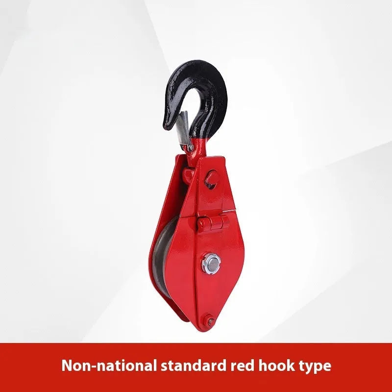 Red industrial steel lifting pulley with a safety latch on the hook.