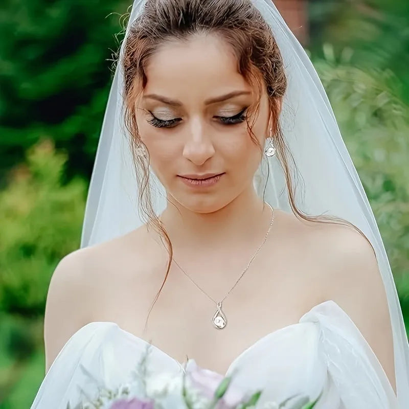 Alloy simulated pearl clavicle chain with diamond inlaid heart pendant, gold finish, on a white background