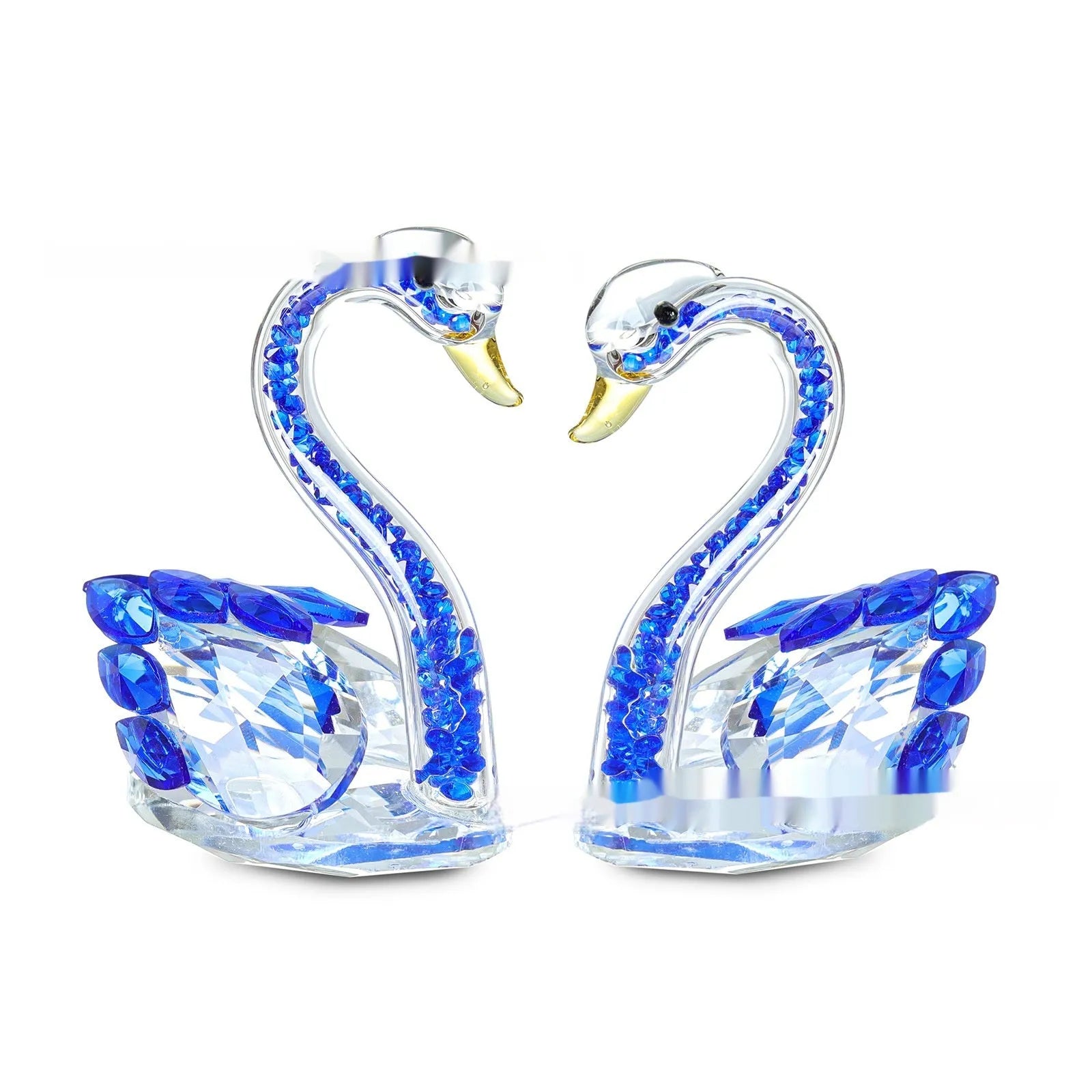 White crystal swan decoration on a desktop in solid head and empty tube styles.