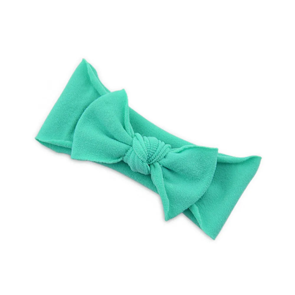 Solid colour knotted cloth headband for baby girls with bowknot design, available in 37 colours