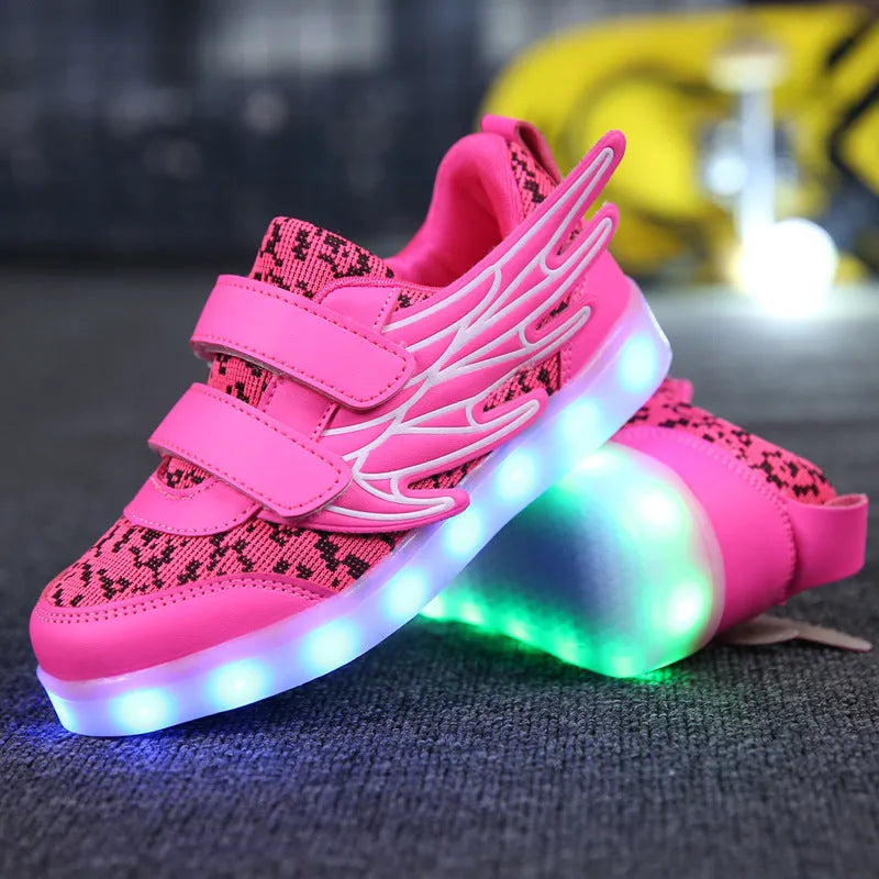 Plum red children's sneakers with LED lights glowing on the soles, showing USB charging port.