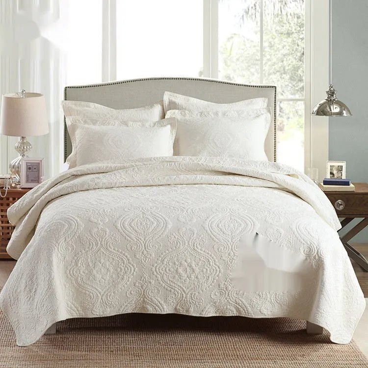 Pure cotton double-sided bed cover three-piece set in a plain colour laid on a bed.