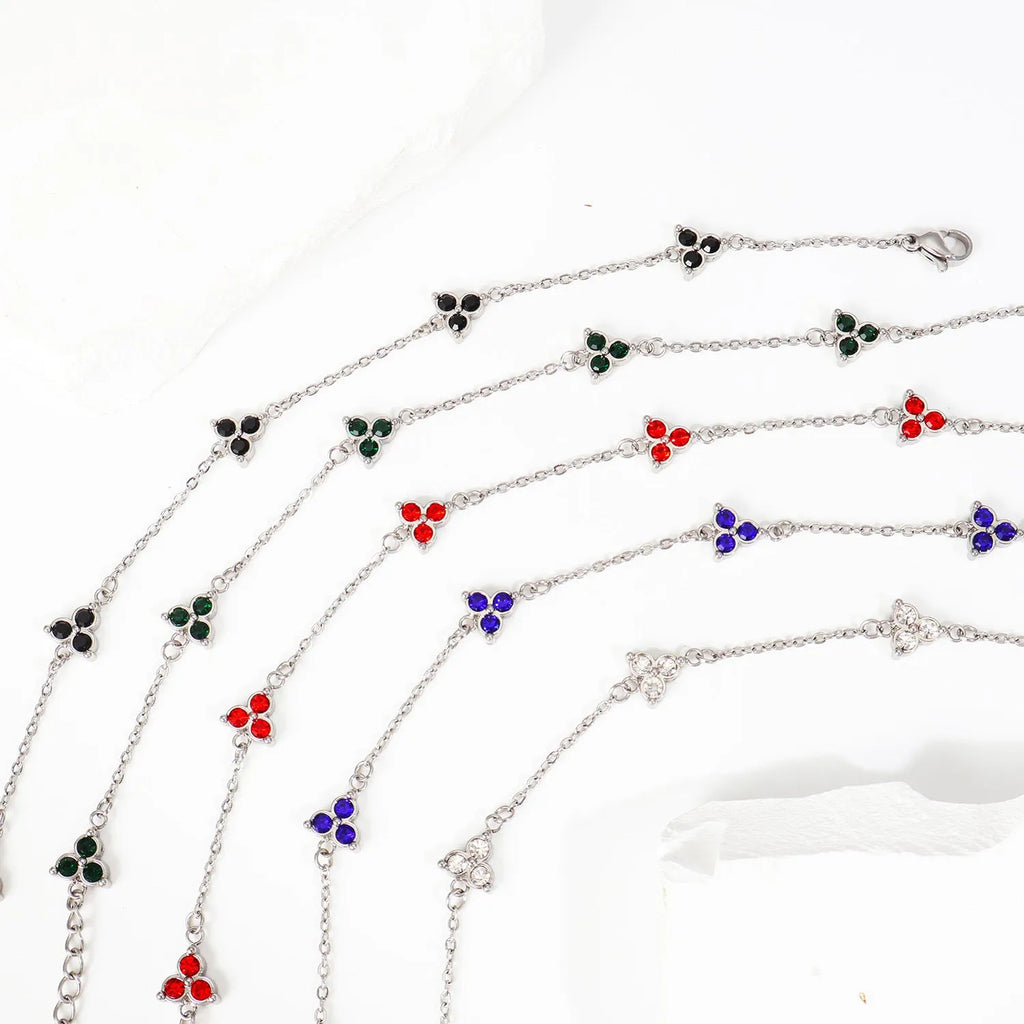 Women's stainless steel geometric bracelet with triangle details and a coloured stone setting.