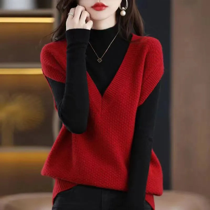 Sleeveless V-neck knitted pullover vest with a raised 3D pattern, shown in a selection of colours on a hanger.