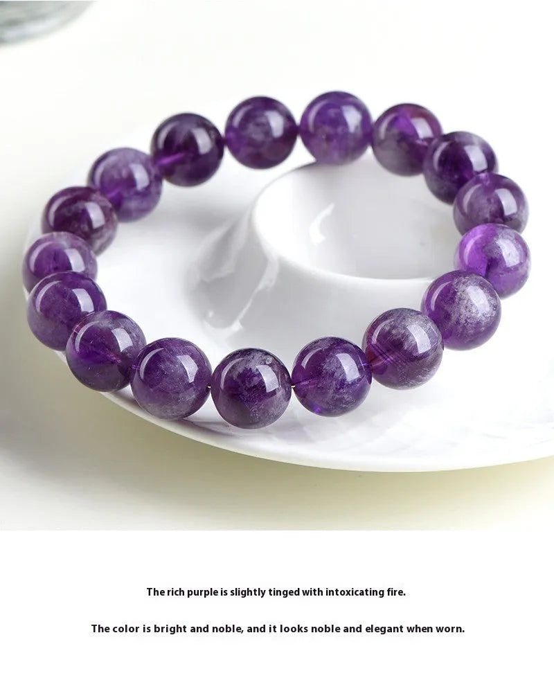 Natural feather amethyst crystal bracelet with scattered beads and a Ruyi symbol in Snow Mountain purple.
