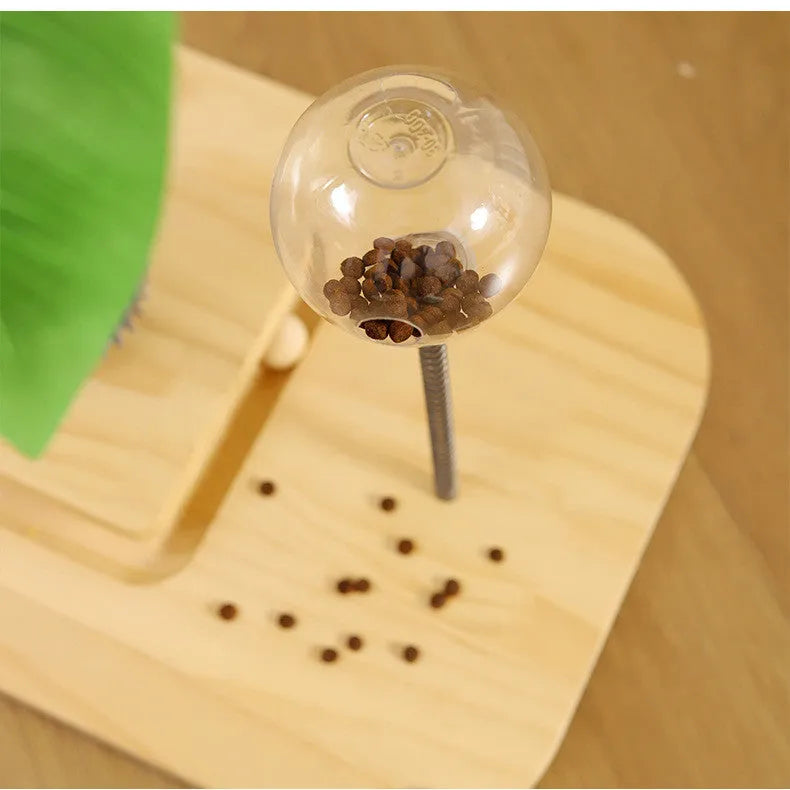 A canna-coloured solid wood cat scratching post with a vertical pole and an integrated food drop ball.