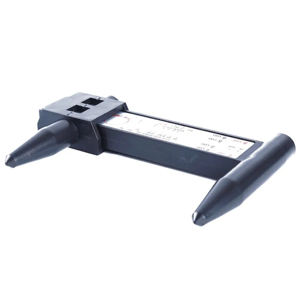 Digital hole distance measuring tool with electronic display, plastic caliper body shown next to a ruler for scale.