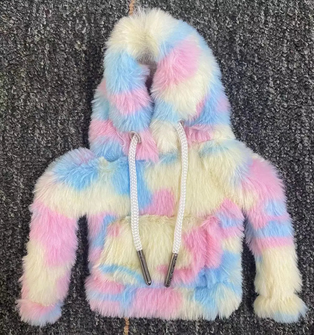 Multicolour cotton handbrake cover hooded over a car gear lever.