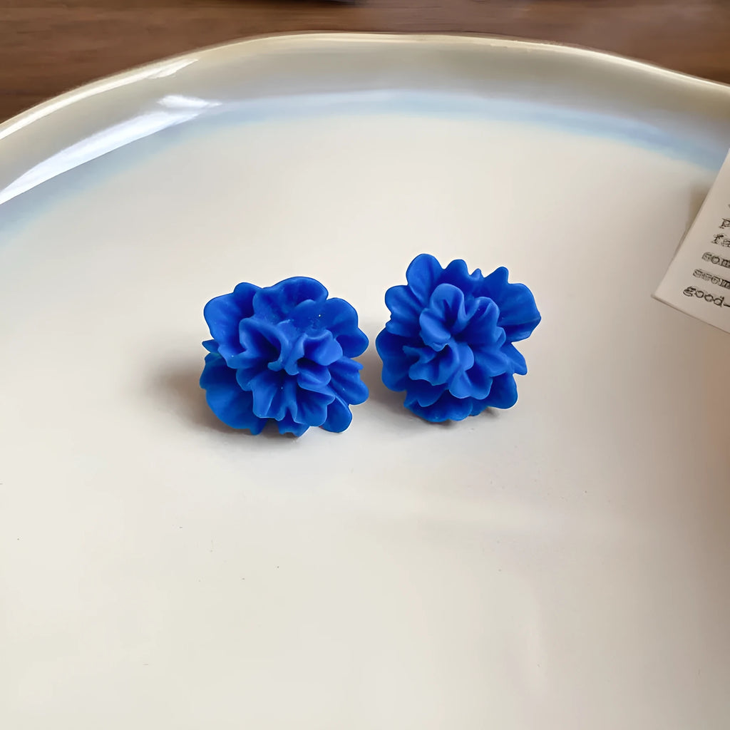 Handmade geometric blue resin flower cloth earrings for women on a silver needle base.