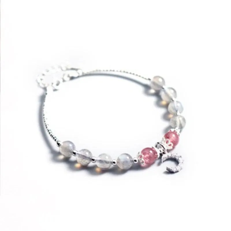 Natural moonstone bracelet with extension chain showing crescent moon and crystal accents
