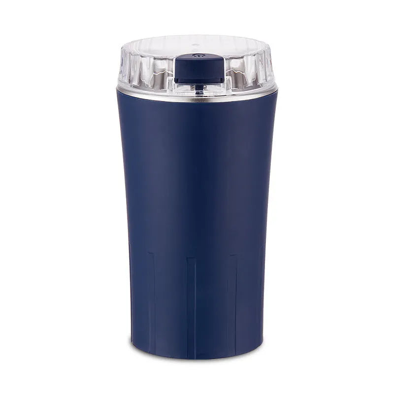 Blue electric mini flour mill and grain grinder with stainless steel construction on a kitchen countertop.
