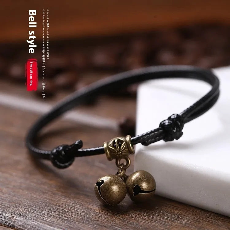Adjustable nylon dog collar with brass bell, shown in black rope colour on a size chart.