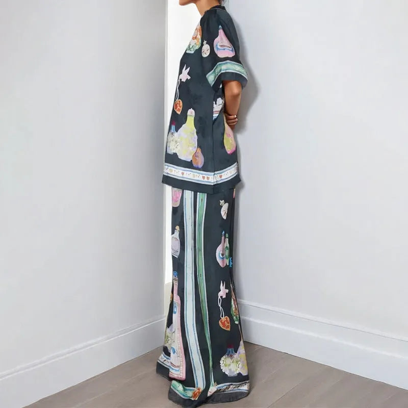 Black women's casual set with cartoon print, featuring a long-sleeve cardigan and trousers.