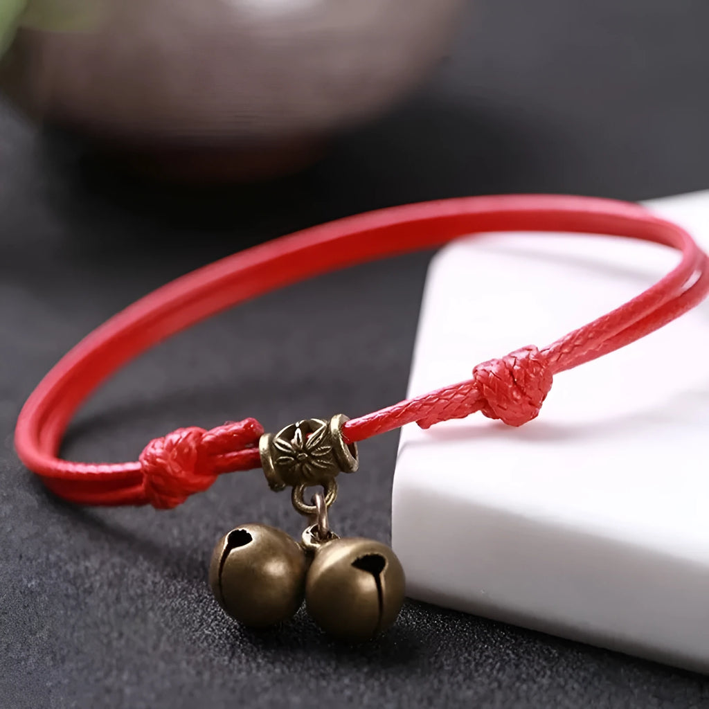 Adjustable nylon dog collar with brass bell, shown in black rope colour on a size chart.