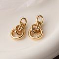A pair of gold geometric earrings for women with an irregular shape, made from copper.