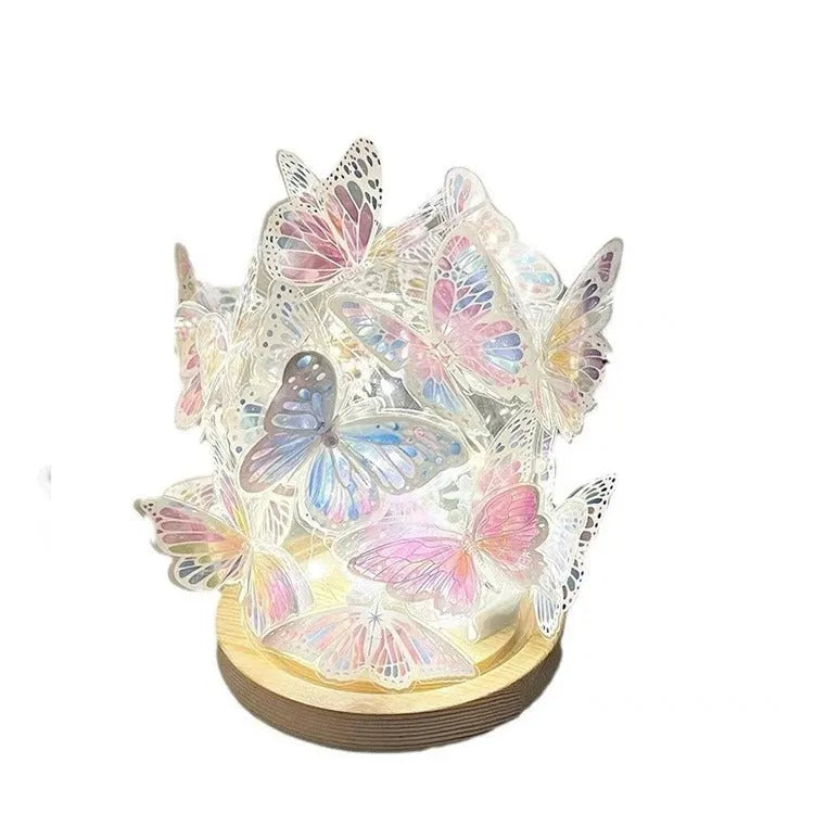 Butterfly-shaped night lamp with glass lampshade on raw wood base