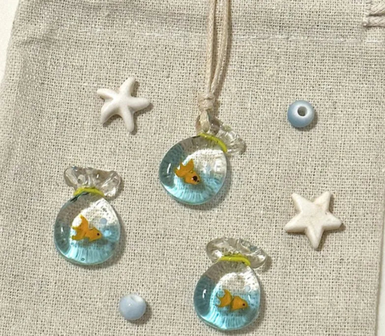 Women's necklace with a coloured glaze Small Fish Lucky Bag pendant on a cotton and linen clavicle chain.