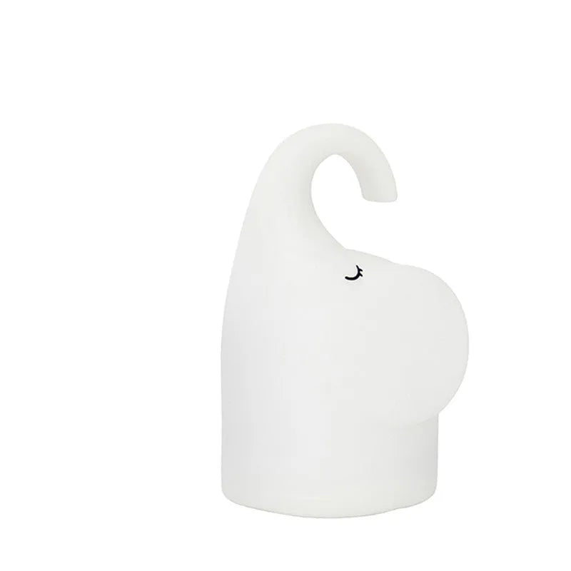 DOMI Elephant silicone night light with warm white glow on bedside table