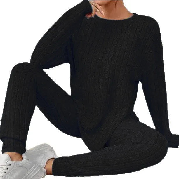 Black sunken stripe two-piece casual homewear set with top and pants on a hanger.