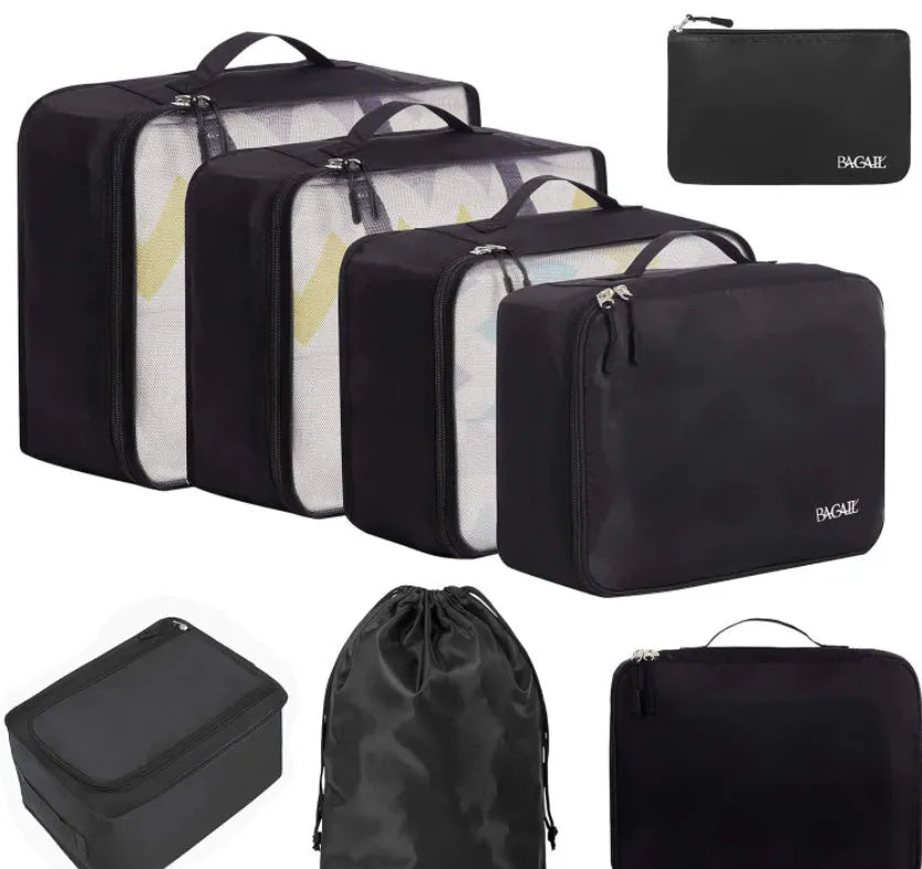 Eight cubic travel packing bags in various colours including beige, black, pink leopard print, and white pink stripes