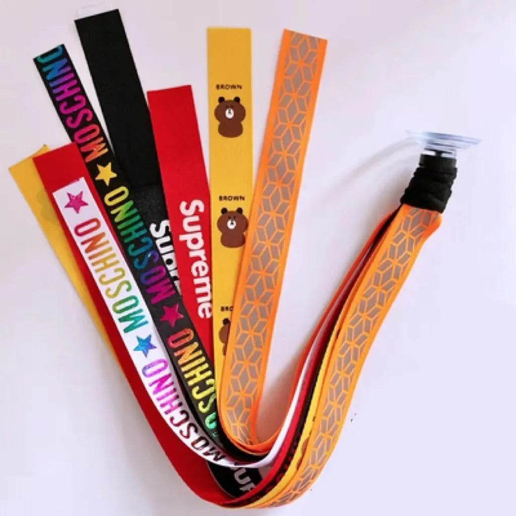 Colourful fabric helmet streamers for children's roller skating and ski helmets, shown in apricot, red, and grey.