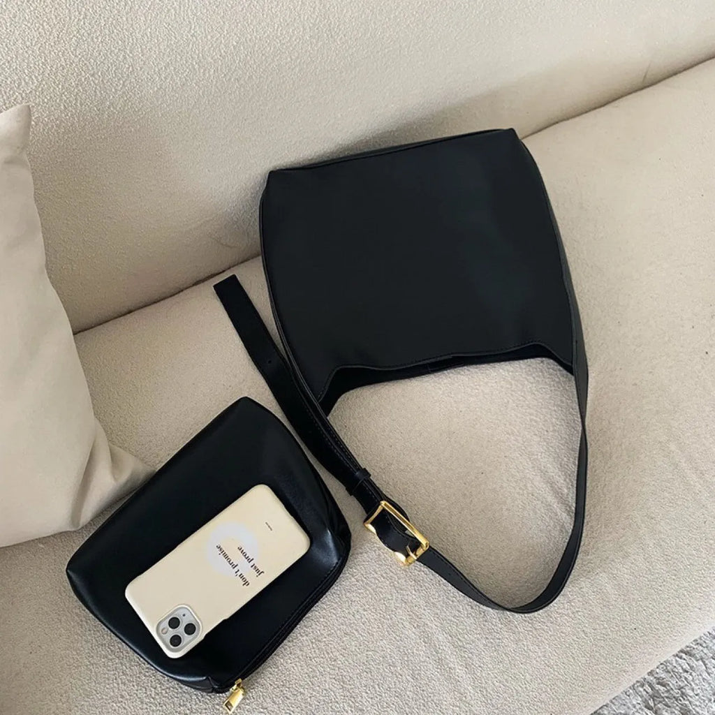 Two women's soft PU leather shoulder bags with swing threads, one black with ribbon and one brown with packet design