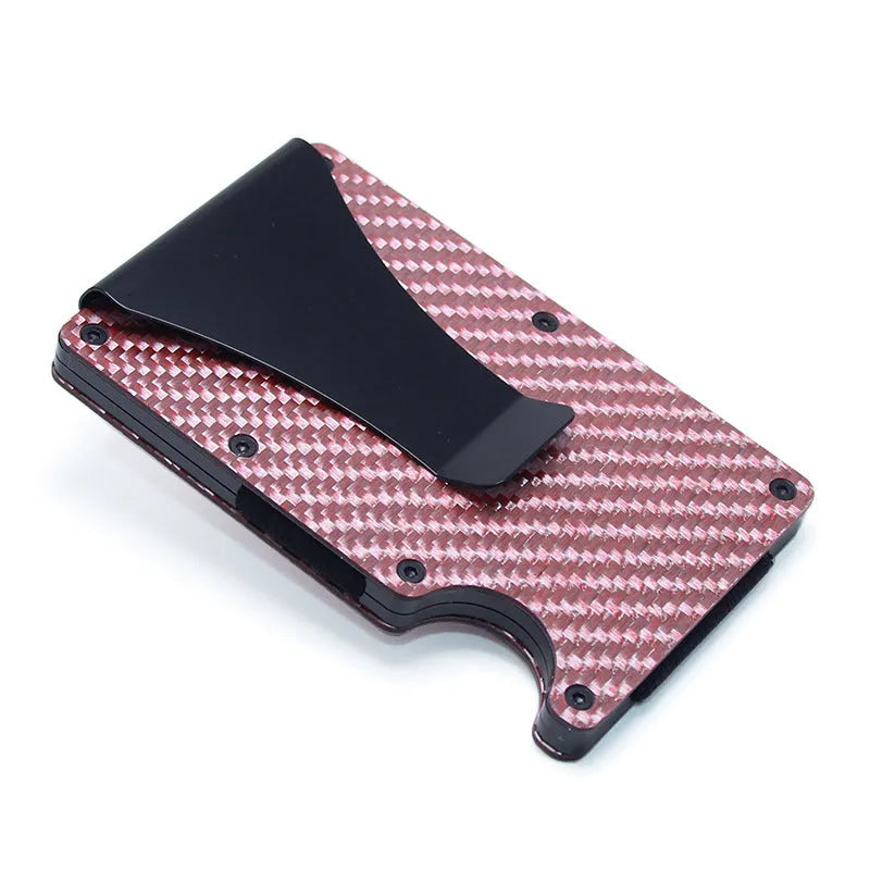 Slim black carbon fibre card holder wallet with geometric design on a table.
