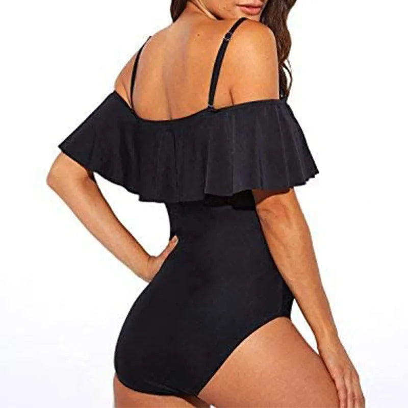 Black one-piece swimsuit with cut-out sections and ruffled strap detailing, tube top style
