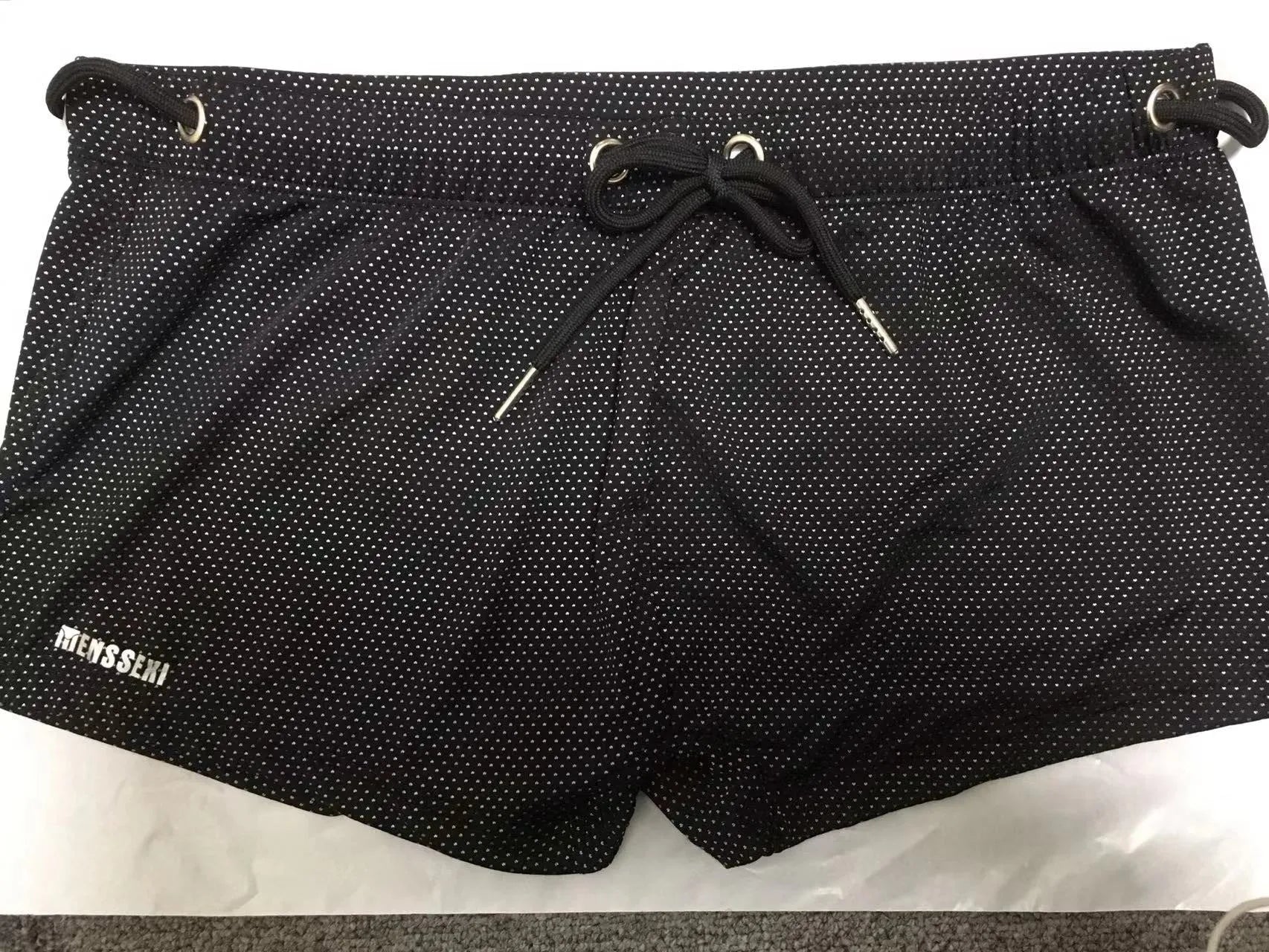 Men's low waist nylon swimming trunks in a solid colour on a white background.