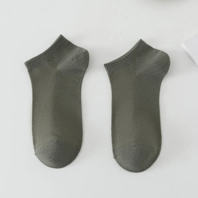 A pair of solid colour low-cut polyester boat socks for men, shown in one of six available colours.