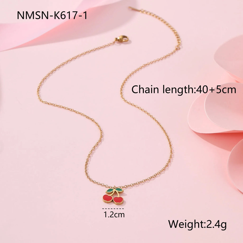 Four-piece stainless steel cherry jewellery set with gold plating: necklace, bracelet, earrings, and ring.