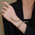 Gold exaggerated twisted snake ring and bracelet jewellery set on display