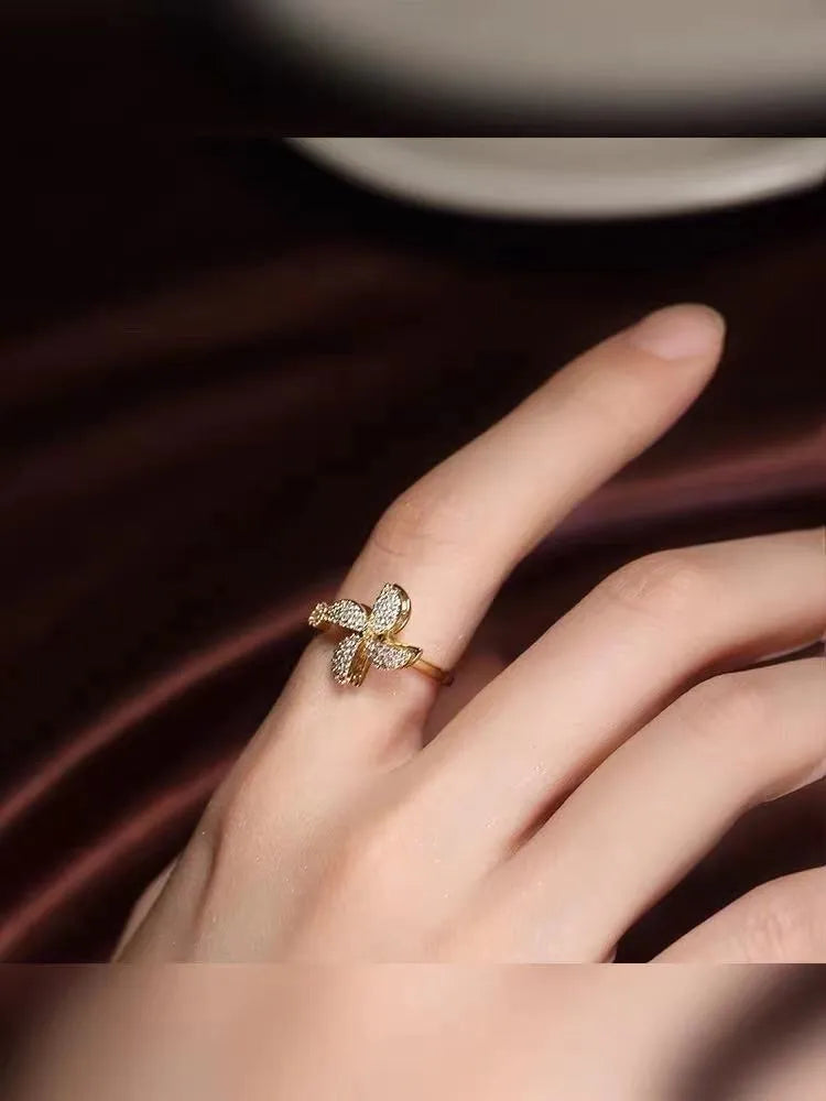 Rotating copper ring with micro-inlaid windmill design in gold or silver electroplated finish