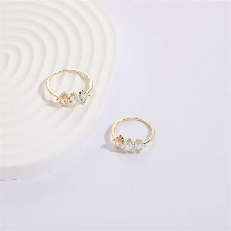 Geometric triangle ring with horse eye design and tricolour zircon stones in gold electroplated finish