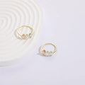Geometric triangle ring with horse eye design and tricolour zircon stones in gold electroplated finish