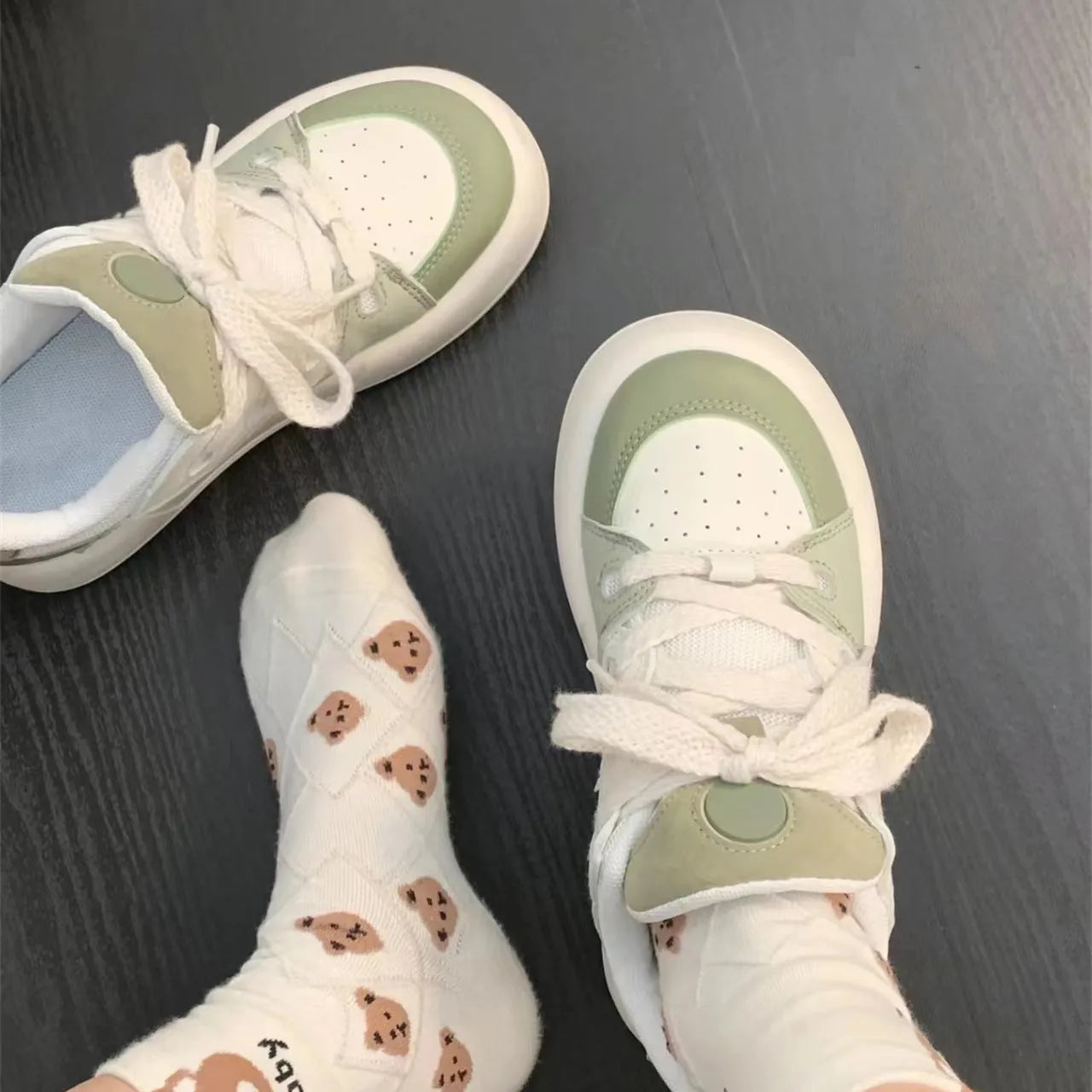 Green women's casual shoes with mesh upper, flat heels, and round toe design