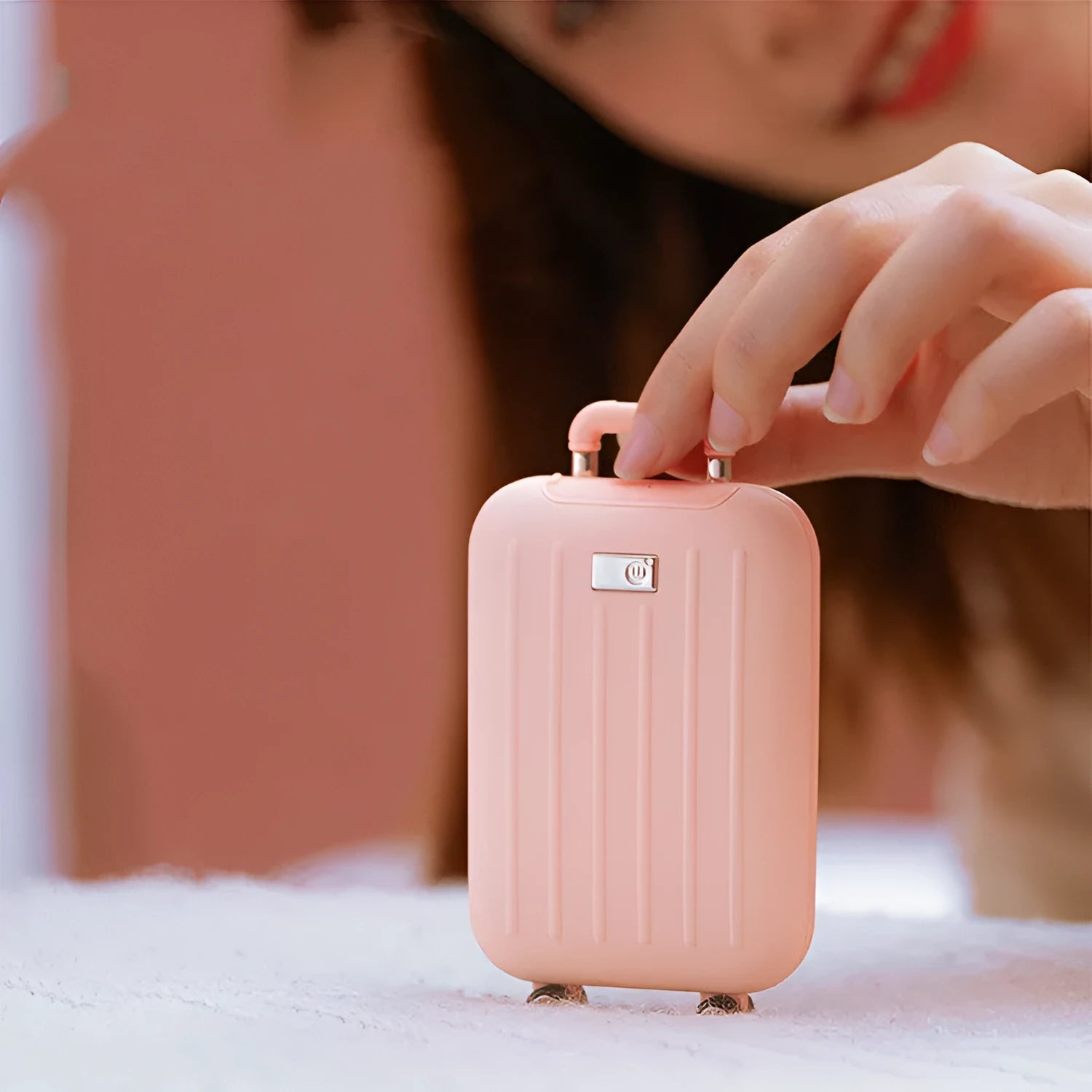 Travel box hand warmer in dark blue with aluminium alloy body showing double-sided heating surface