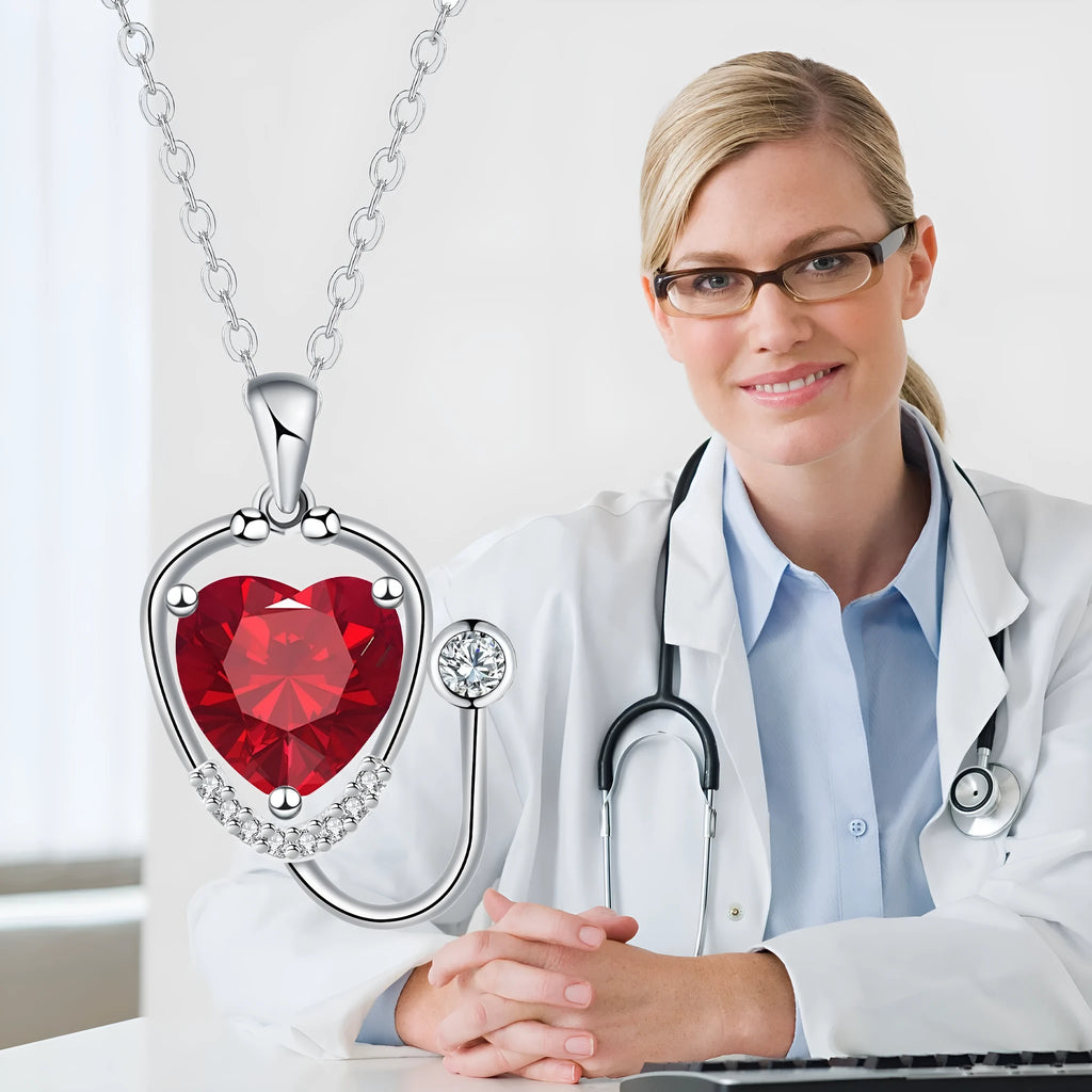Copper women's necklace with wings cross stethoscope pendant in red diamond electroplated finish.