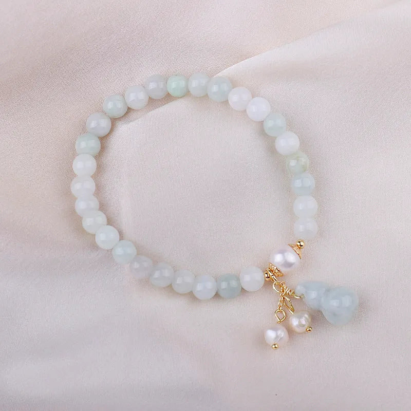 Chinese style jade bracelet with gourd design and pearl accents in natural emerald colour