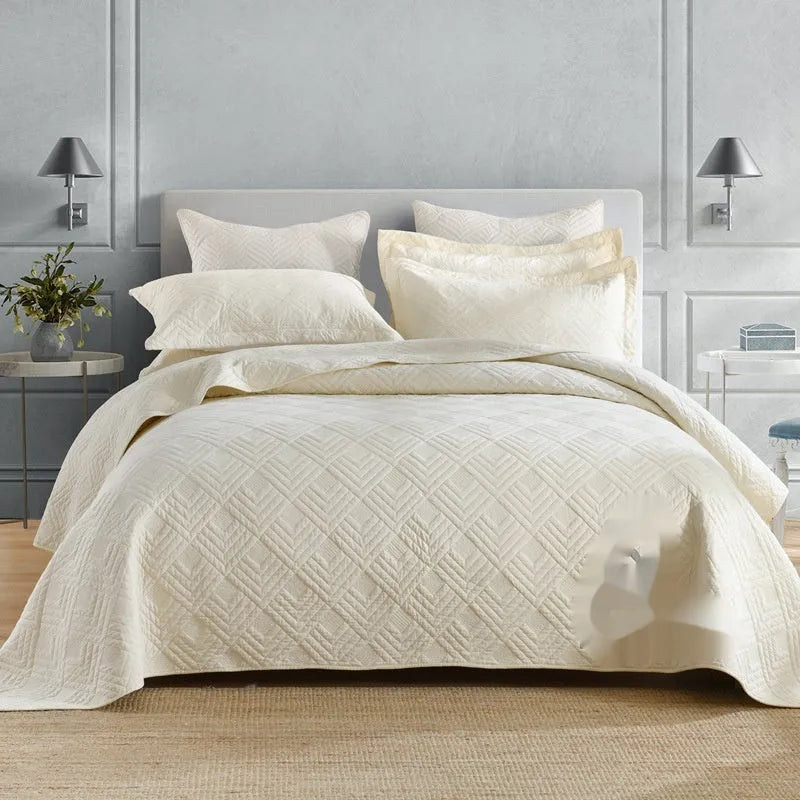 Pure cotton double-sided bed cover three-piece set in a plain colour laid on a bed.
