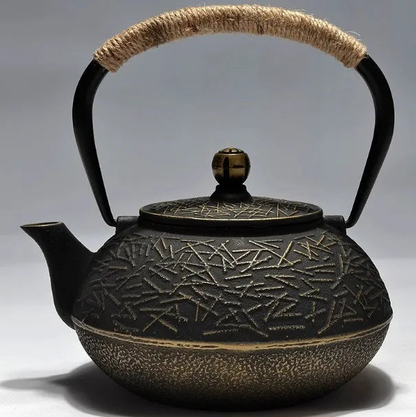 Japanese cast iron teapot in black with Peony pattern, showing lid, handle, and spout.
