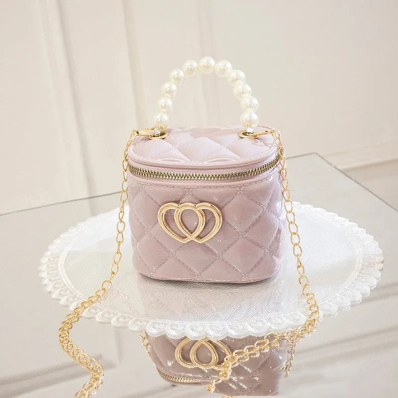 Women's white PVC bucket gel handbag with a red heart-shaped pattern lining.