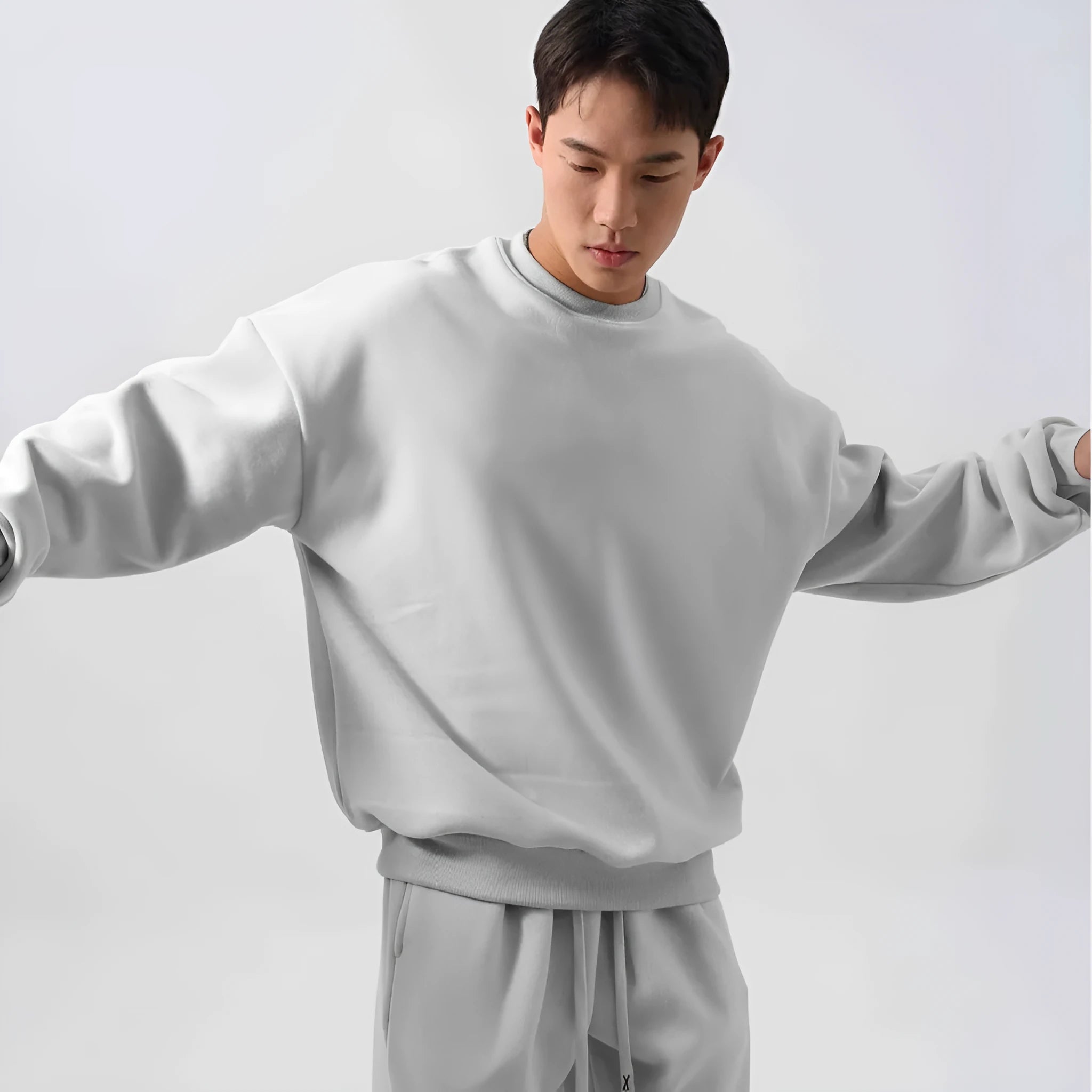 Men's polar fleece tracksuit set showing crew neck top with padded trousers in winter sportswear style
