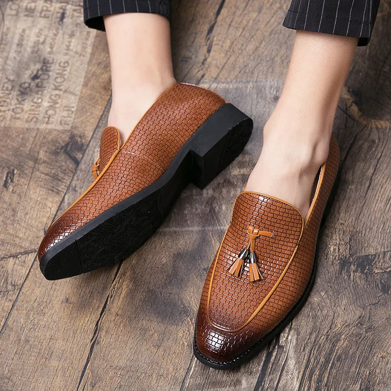 Men's black pointed-toe slip on shoes with a tassel detail on the low-top PU upper.