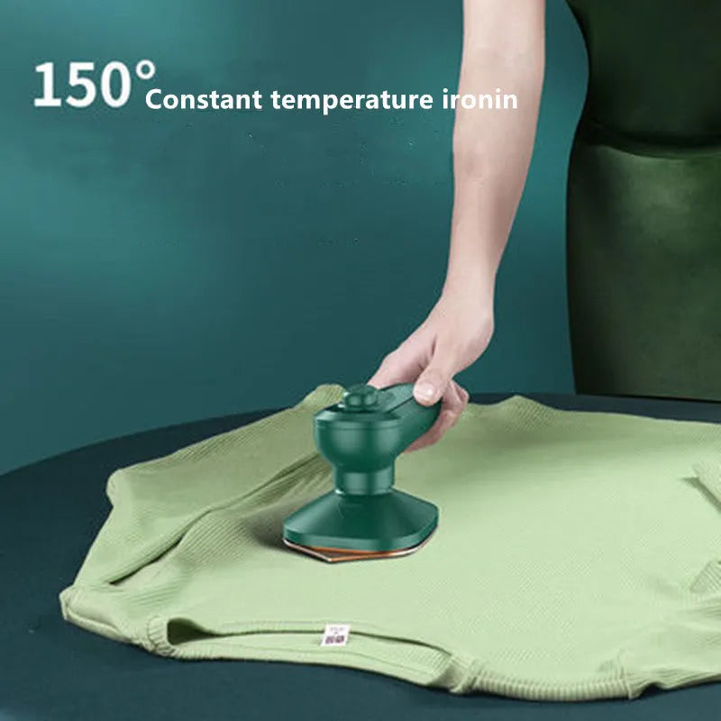 Dark green portable handheld hanging steam ironing machine with ceramic panel and power cord.